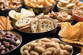 An assortment of indulgent snacks, including chocolate, pastries, and sweet and salty gourmet treats